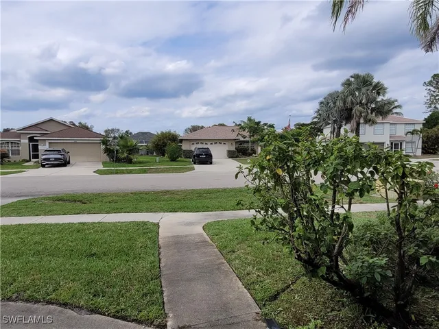 a view of a garden with a building in the background