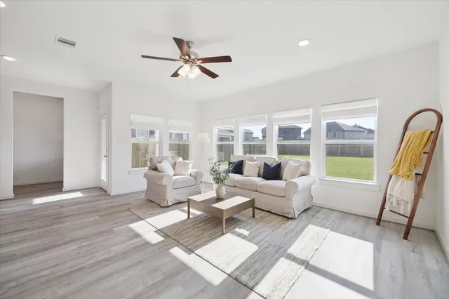 a living room with furniture and a large window