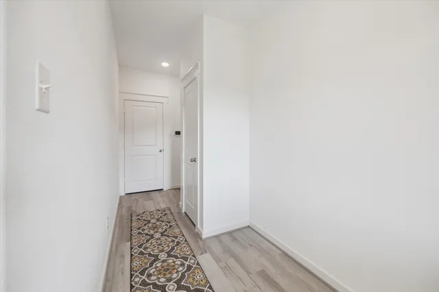a view of hallway with wooden floor