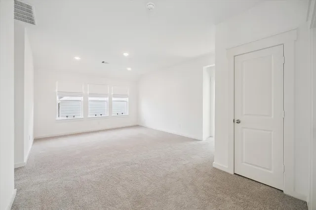 a view of an empty room and a window