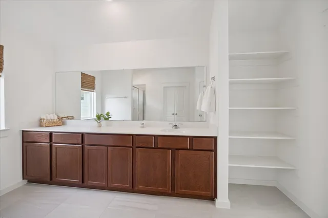 a spacious bathroom with a double vanity sink and a mirror
