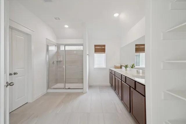 a bathroom with a double vanity sink and mirror