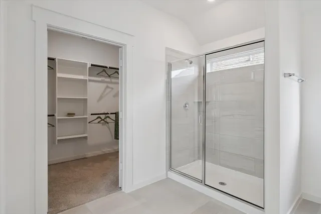 a bathroom with a glass shower door