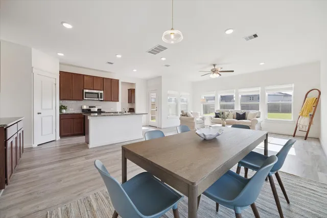 a view of a dining room with furniture and wooden floor
