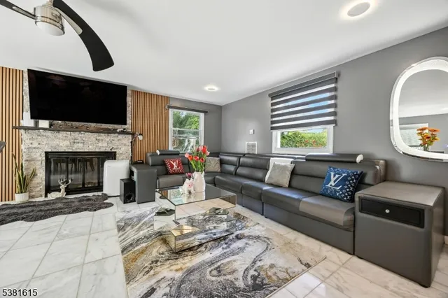 a living room with furniture fireplace and a flat screen tv