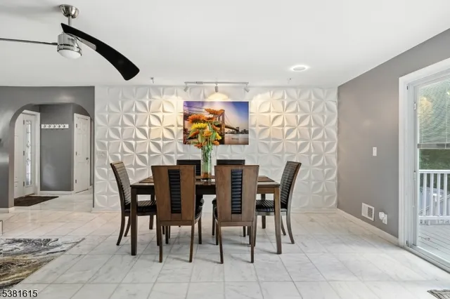 a view of a dining room with furniture and a chandelier