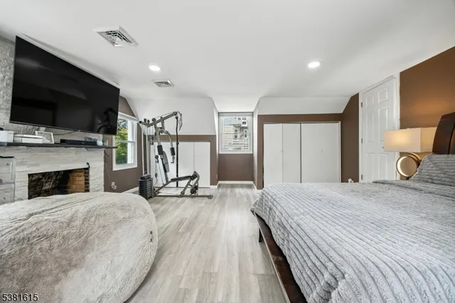 a spacious bedroom with a bed and a flat screen tv