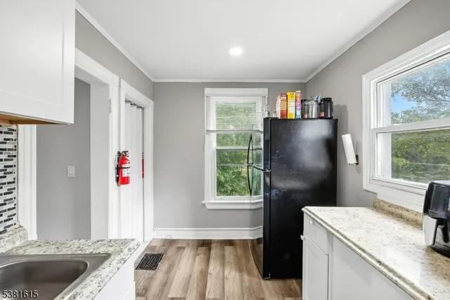 a kitchen with a refrigerator and a sink