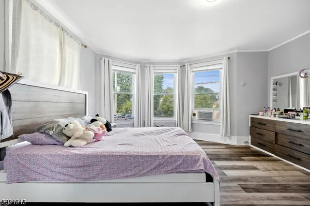a bedroom with a bed and large window