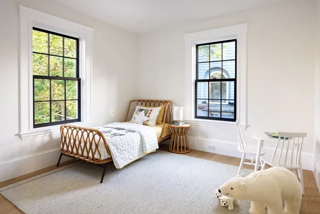 a bedroom with a large bed and a window
