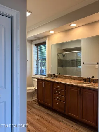 a spacious bathroom with a granite countertop sink mirror and toilet