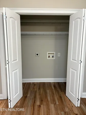 a view of walk in closet with wooden floor