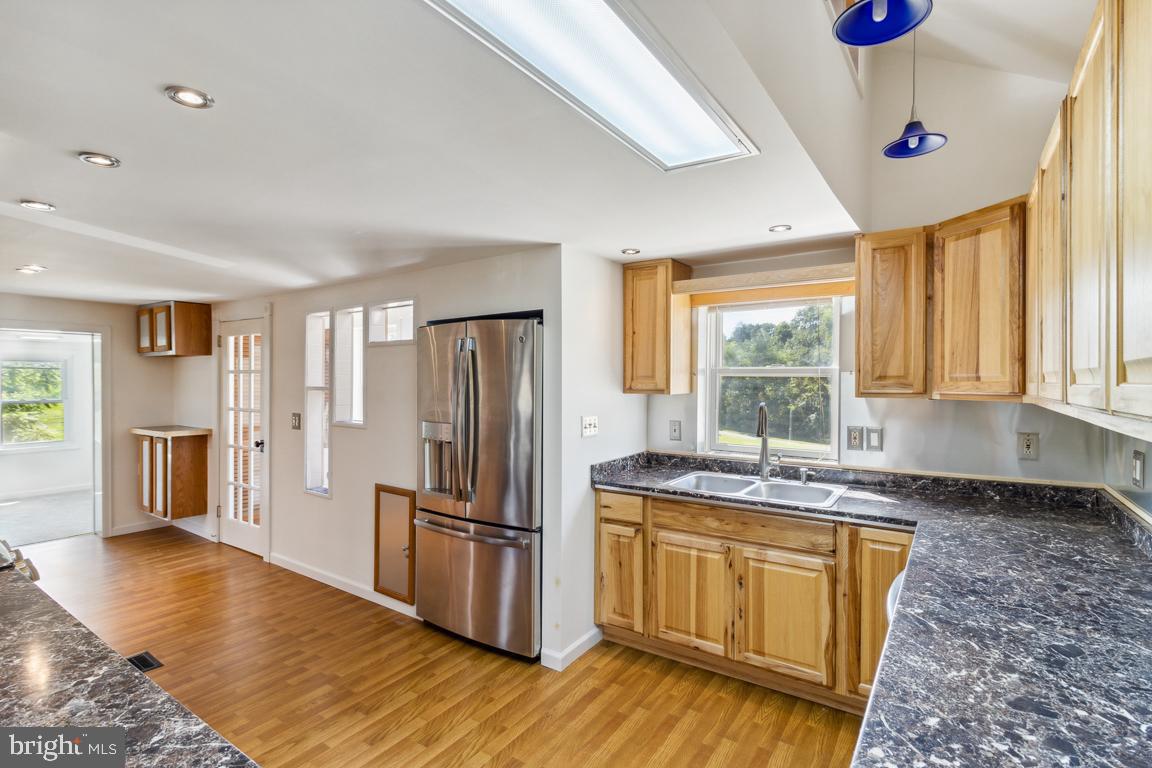 2300 Liberty Road Sykesville, MD 21784 - Photo 11 of 25 a kitchen with granite countertop a stove a sink dishwasher a refrigerator and wooden floor