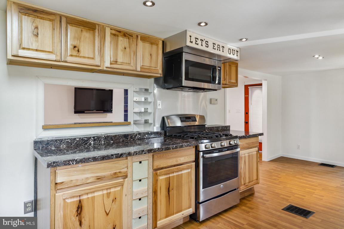 2300 Liberty Road Sykesville, MD 21784 - Photo 12 of 25 a kitchen with stainless steel appliances granite countertop a stove microwave and oven
