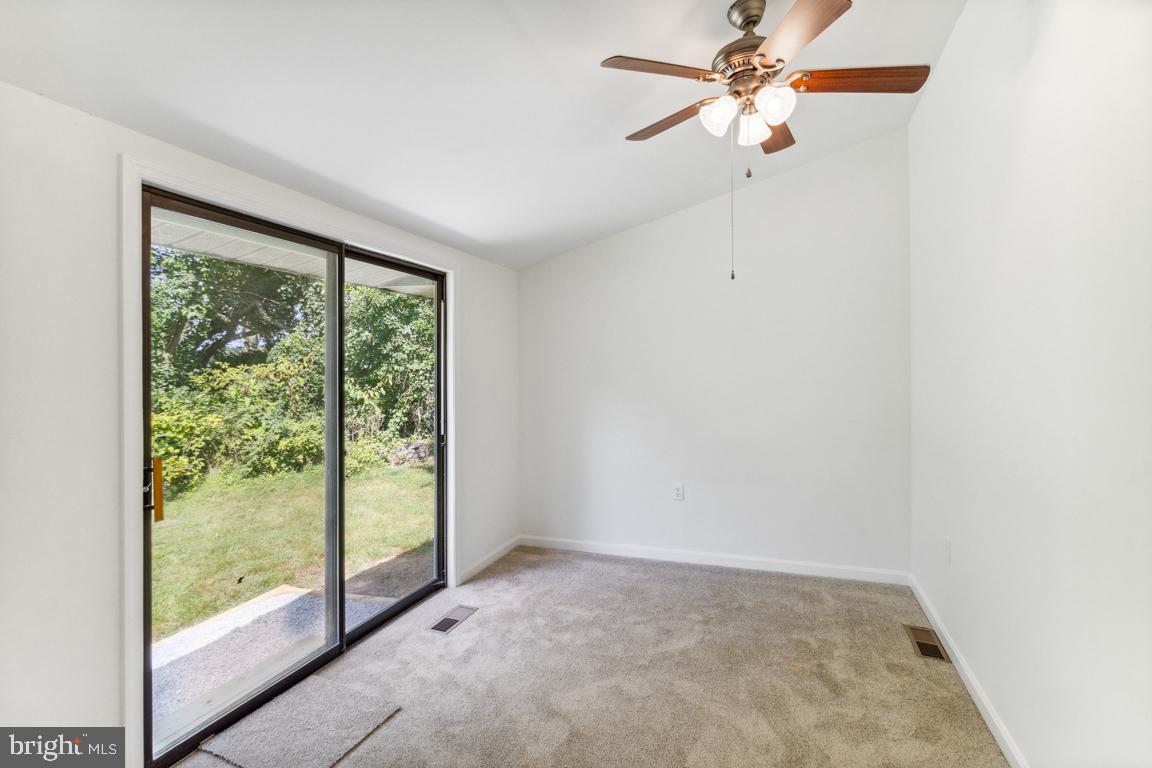 2300 Liberty Road Sykesville, MD 21784 - Photo 15 of 25 a view of a big room with windows and chandelier fan