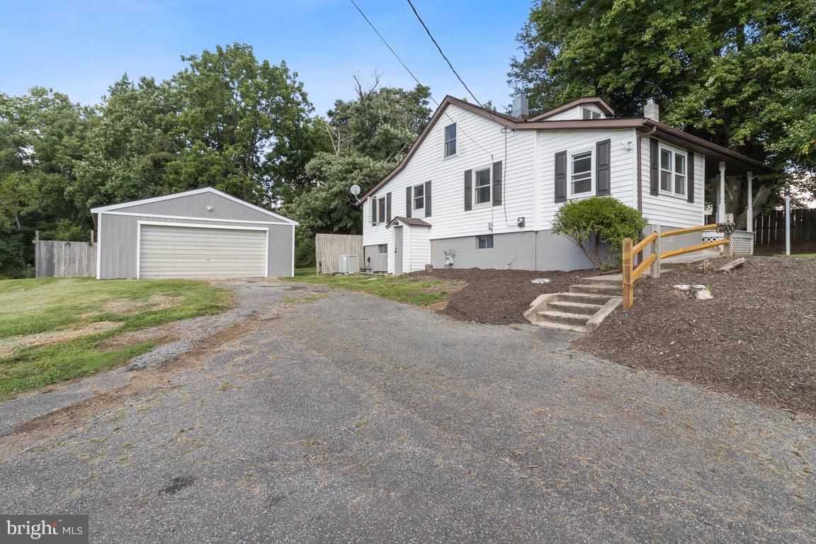 2300 Liberty Road Sykesville, MD 21784 - Photo 2 of 25 a front view of a house with a yard and garage