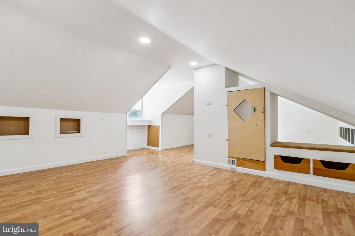 2300 Liberty Road Sykesville, MD 21784 - Photo 21 of 25 a view of an empty room with wooden floor and a window