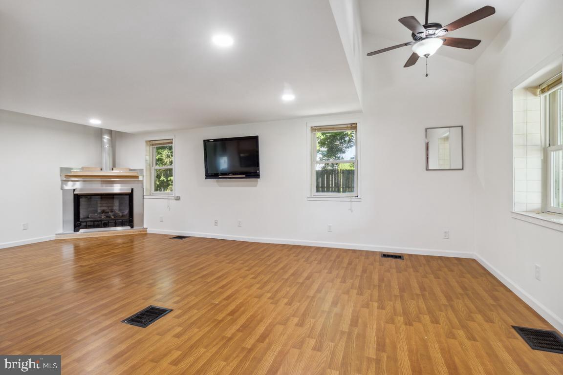 2300 Liberty Road Sykesville, MD 21784 - Photo 4 of 25 a view of empty room with wooden floor and fan