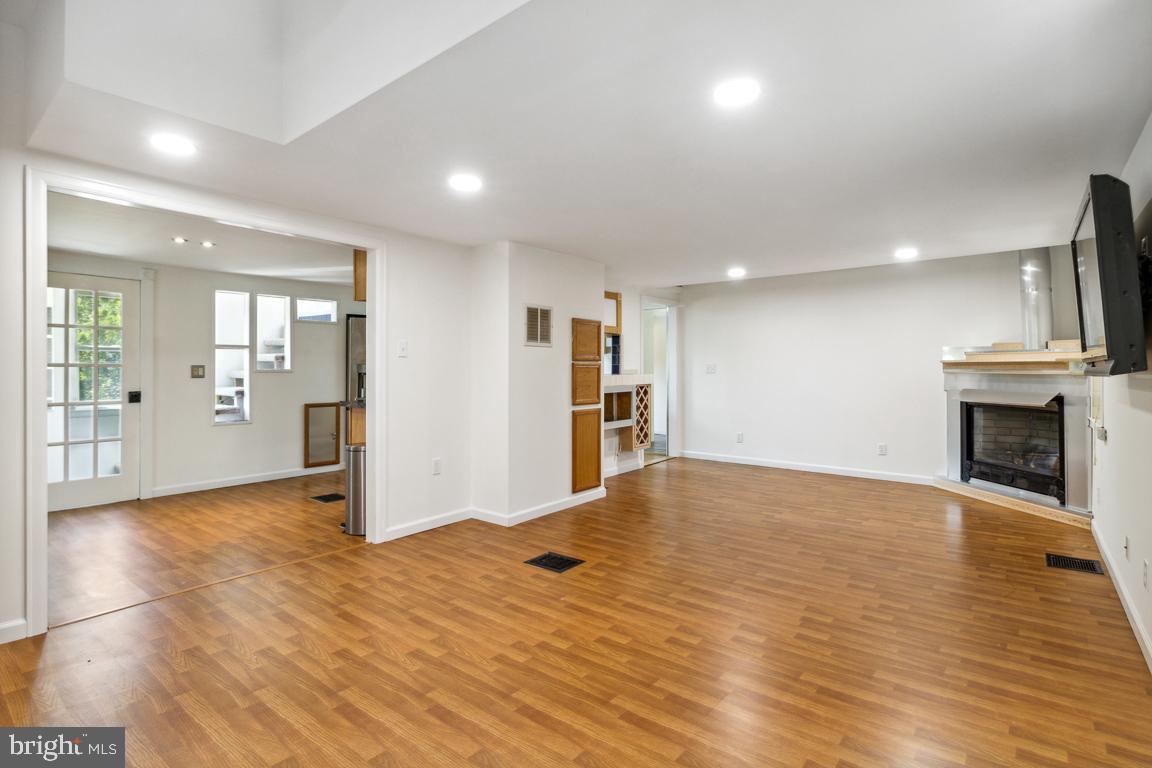 2300 Liberty Road Sykesville, MD 21784 - Photo 5 of 25 a view of a livingroom with wooden floor and a kitchen