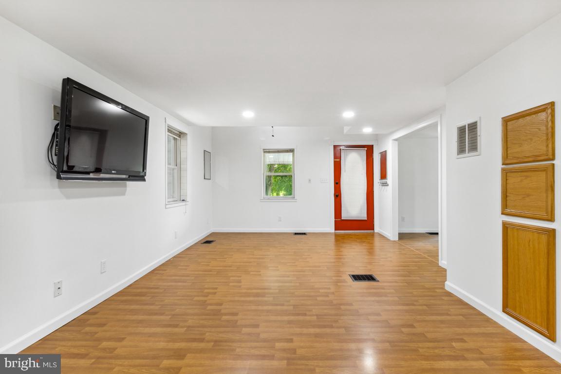 2300 Liberty Road Sykesville, MD 21784 - Photo 7 of 25 a view of empty room with wooden floor and fan