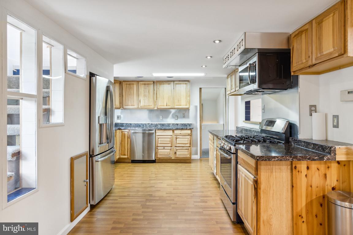 2300 Liberty Road Sykesville, MD 21784 - Photo 9 of 25 a kitchen with stainless steel appliances granite countertop a refrigerator a stove and a sink