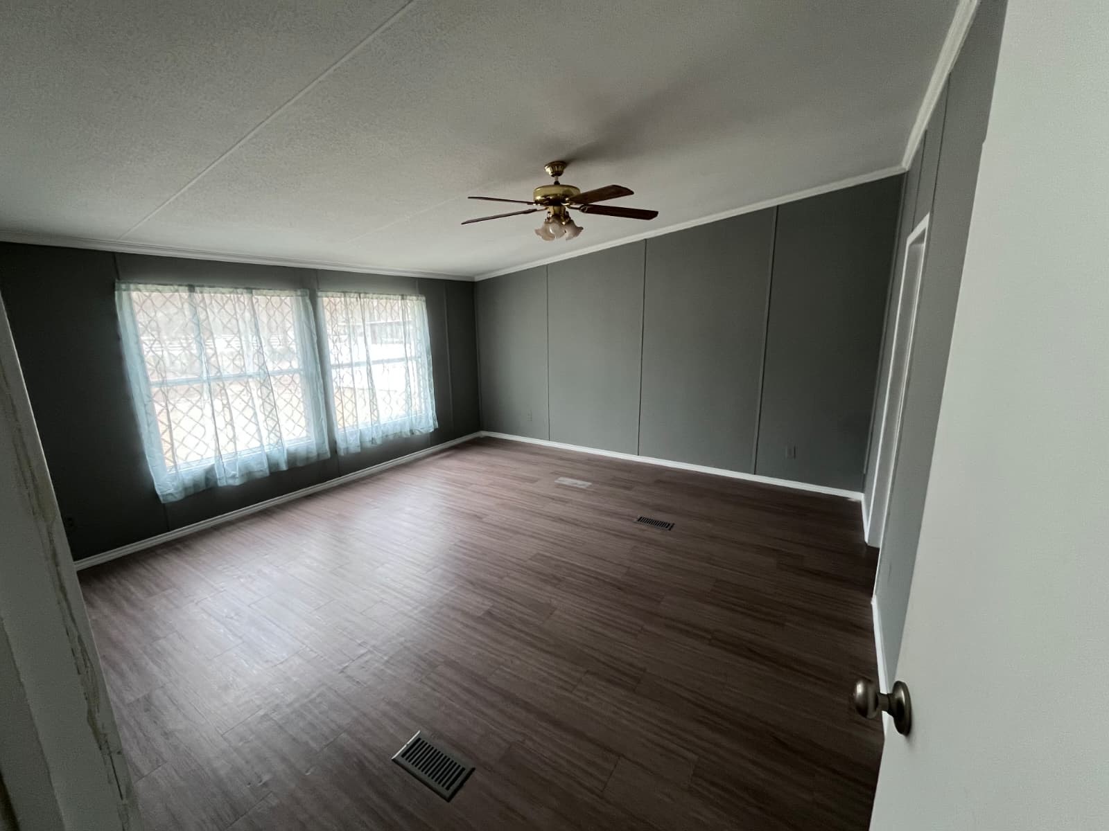 14912 Hannah Way Conroe, TX 77302 - Photo 16 of 20 an empty room with wooden floor ceiling fan and windows