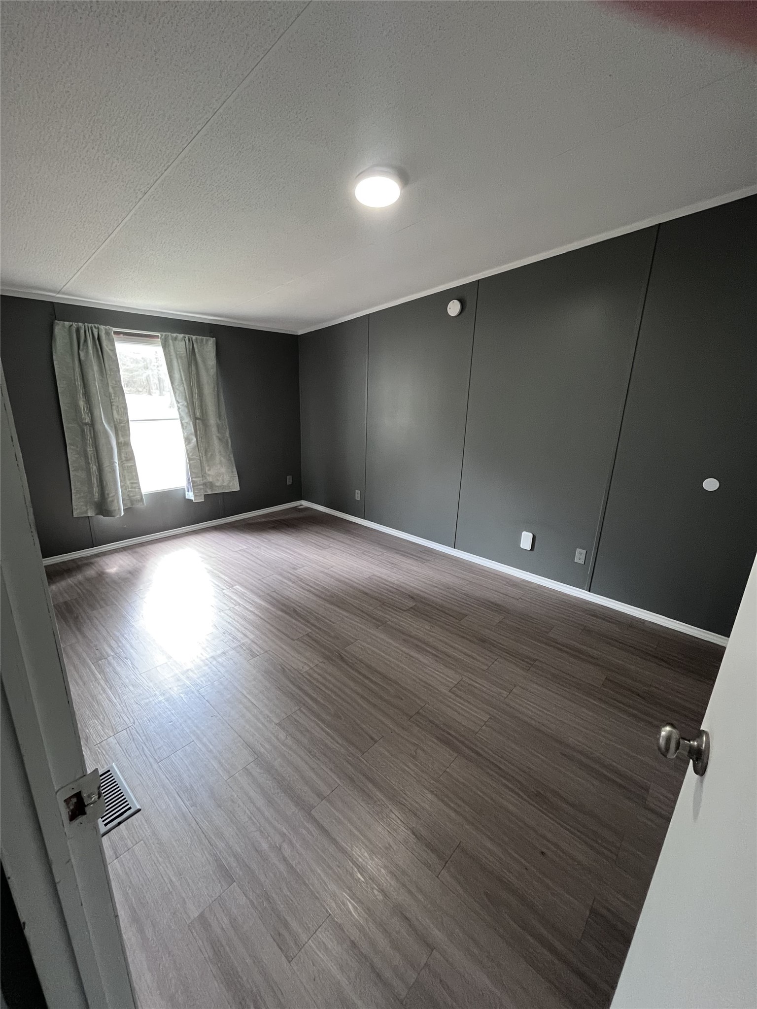 14912 Hannah Way Conroe, TX 77302 - Photo 18 of 20 an empty room with wooden floor and windows