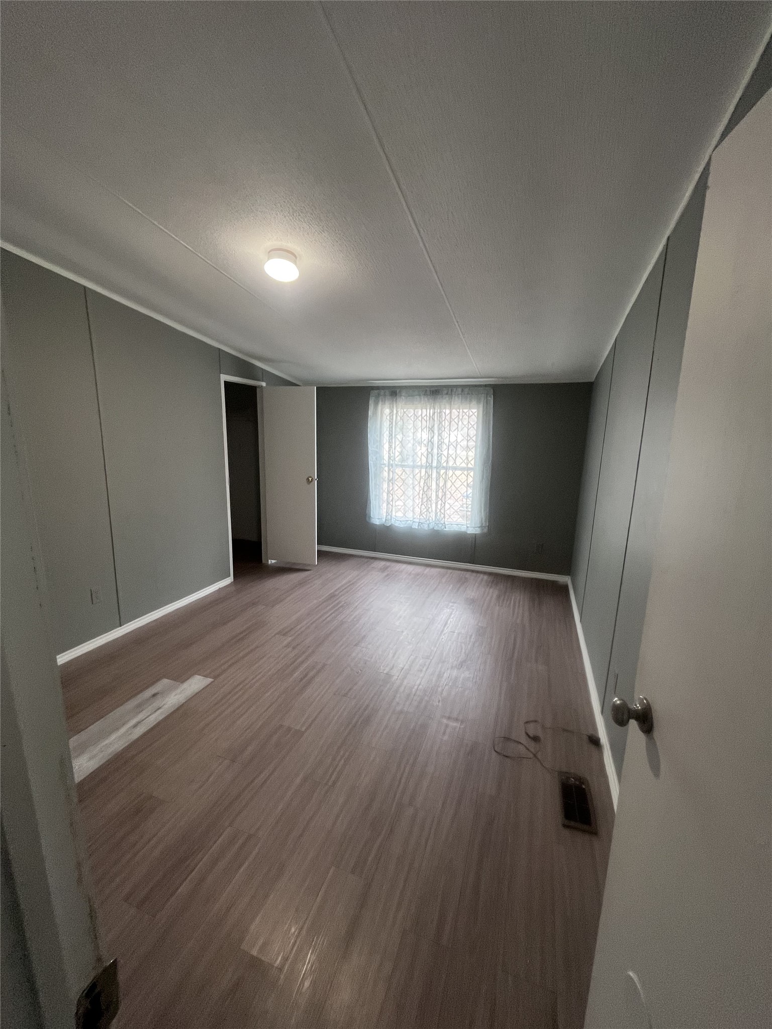 14912 Hannah Way Conroe, TX 77302 - Photo 20 of 20 a view of an empty room with wooden floor and a window