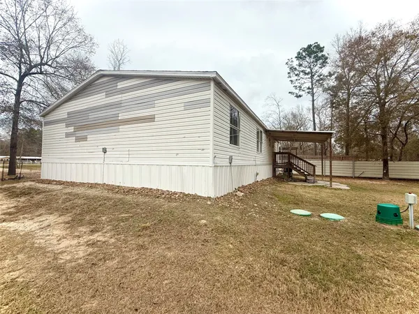 a swimming pool with outdoor seating and yard