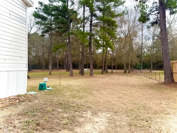 a backyard of a house with swimming pool and tree