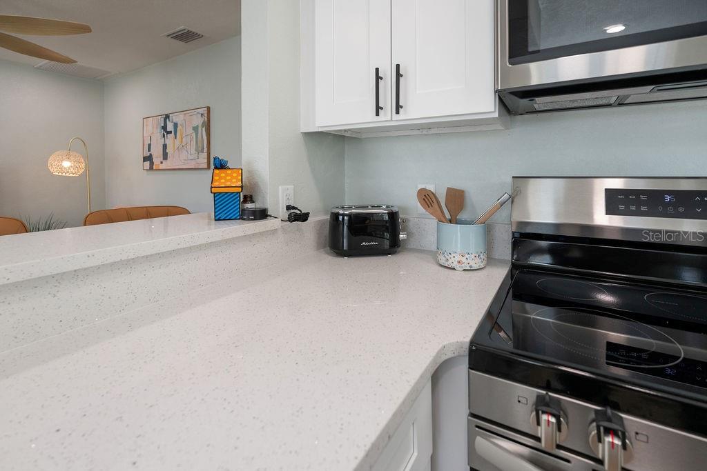 11987 Maple Street Dunnellon, FL 34432 - Photo 59 of 72 a kitchen with stainless steel appliances granite countertop a stove and a microwave