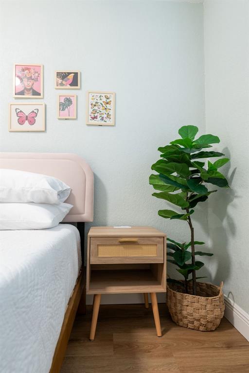 11987 Maple Street Dunnellon, FL 34432 - Photo 67 of 72 a bedroom with a bed table and a potted plant