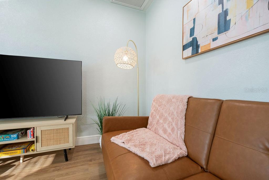 11987 Maple Street Dunnellon, FL 34432 - Photo 70 of 72 a living room with furniture and a flat screen tv