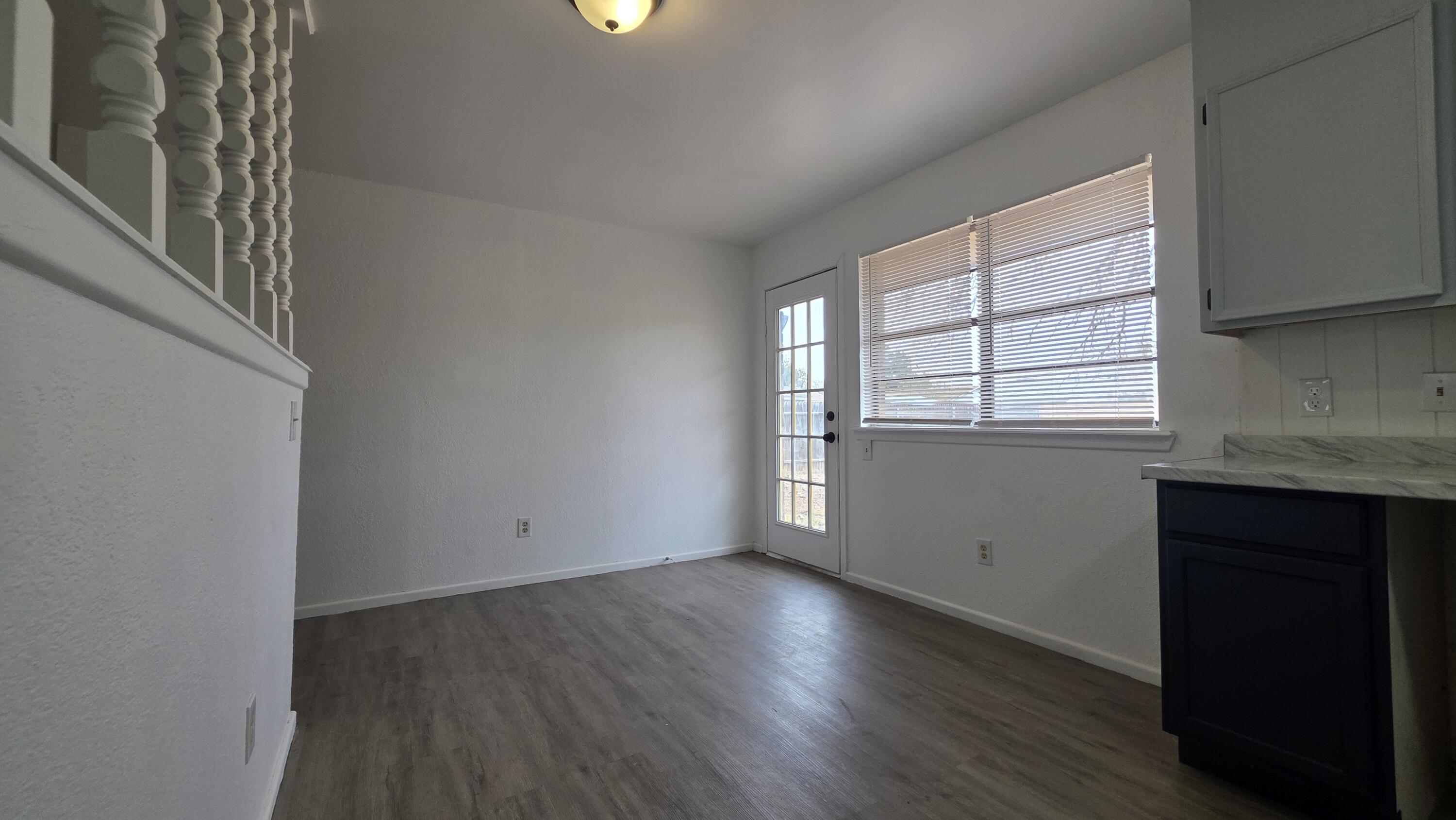 2307 78th Street Lubbock, TX 79423 - Photo 12 of 21 an empty room with wooden floor and windows