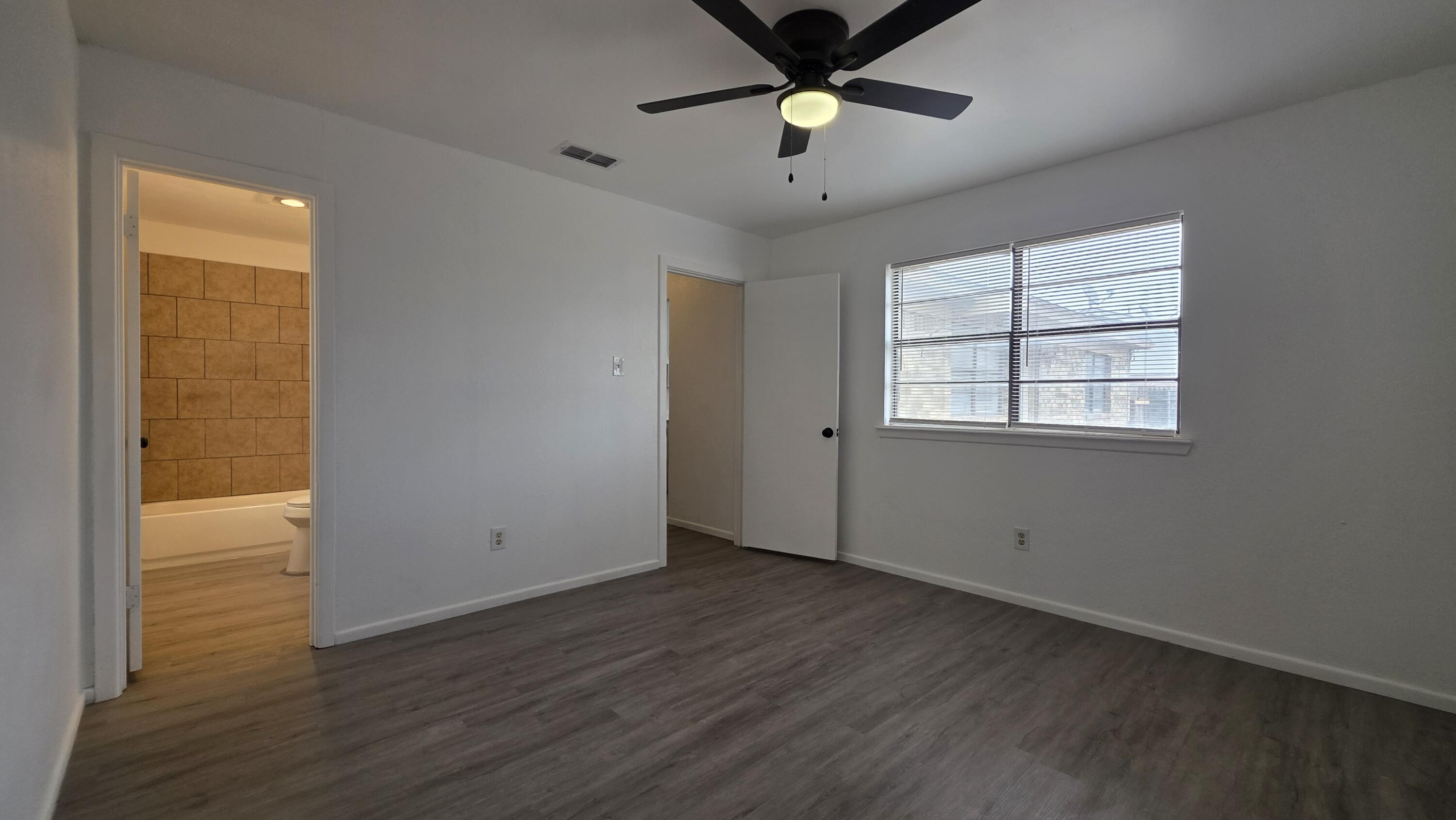 2307 78th Street Lubbock, TX 79423 - Photo 14 of 21 an empty room with wooden floor and windows