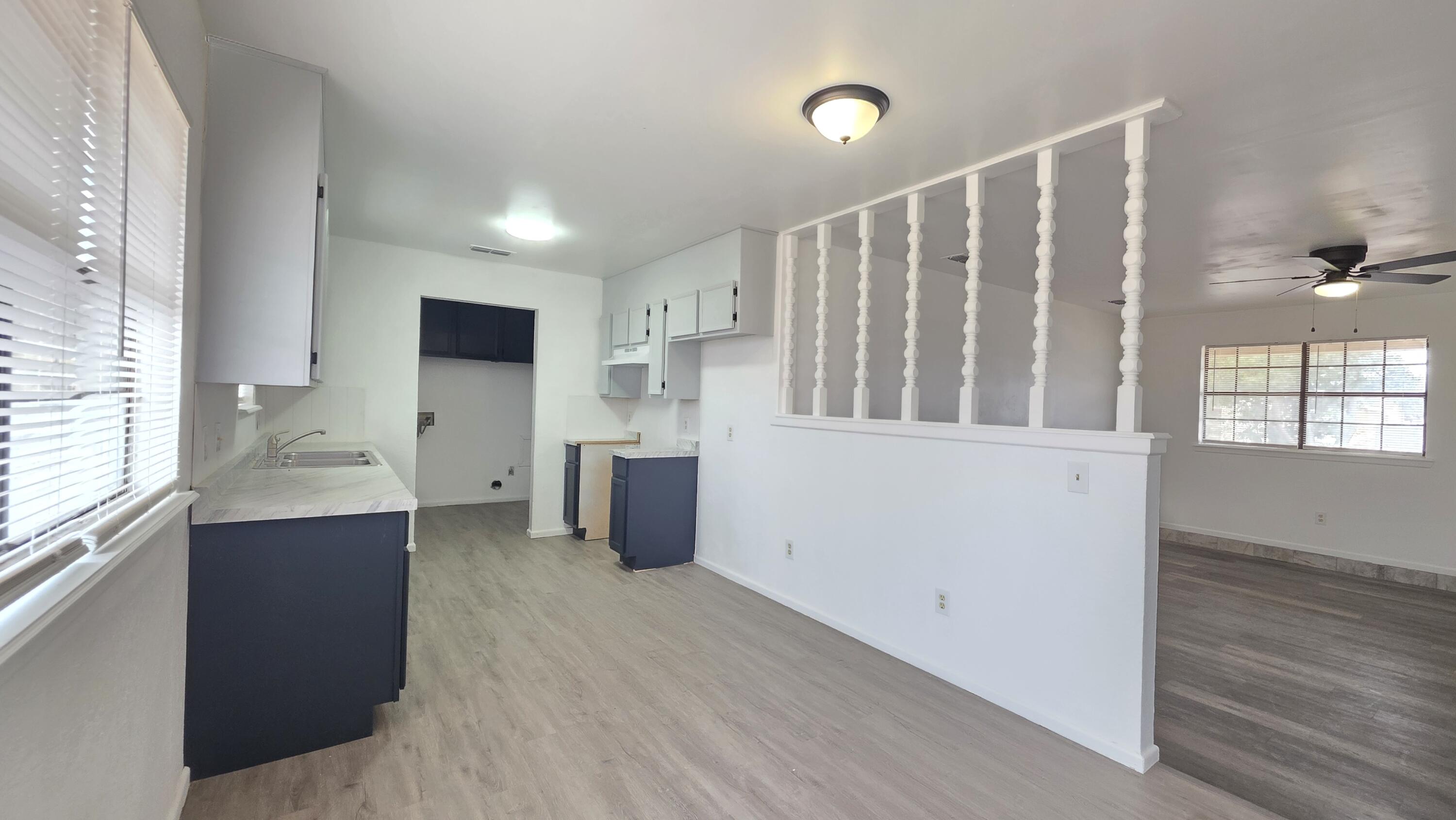 2307 78th Street Lubbock, TX 79423 - Photo 16 of 21 a view of kitchen with wooden floor and electronic appliances