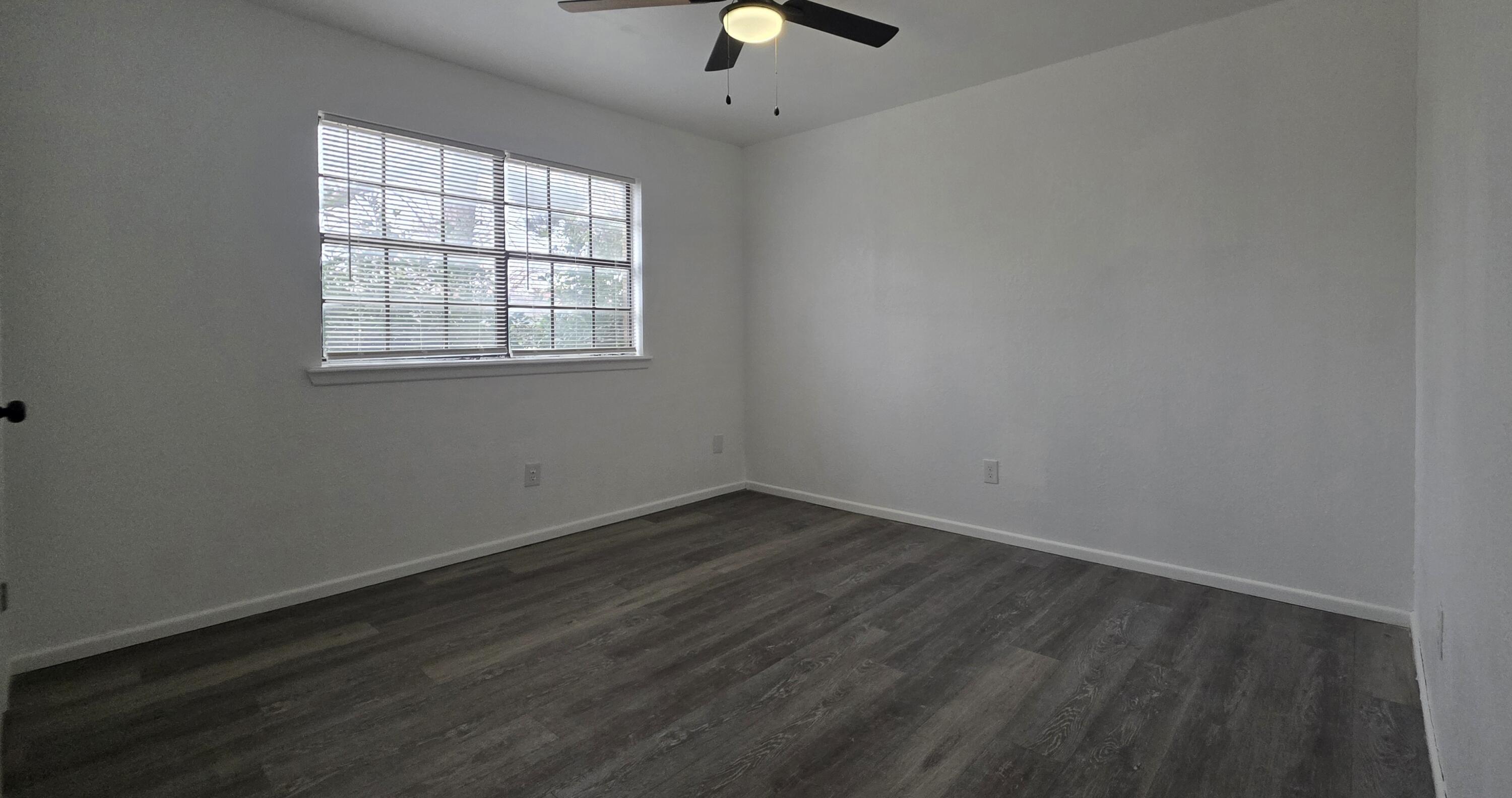 2307 78th Street Lubbock, TX 79423 - Photo 17 of 21 an empty room with wooden floor and windows