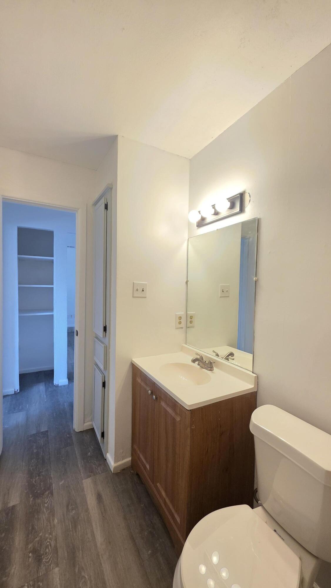 2307 78th Street Lubbock, TX 79423 - Photo 19 of 21 a bathroom with a toilet a sink and mirror