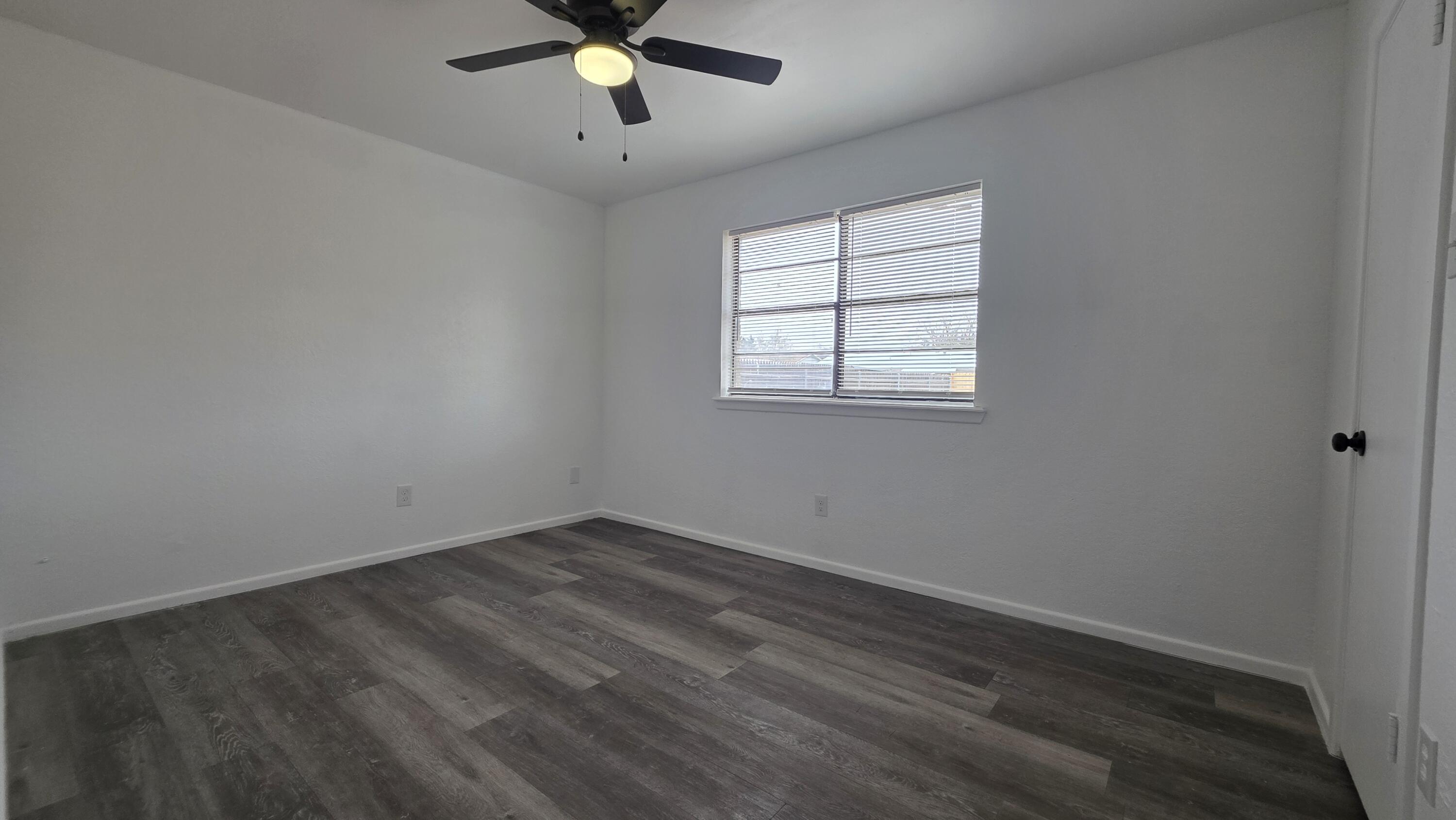 2307 78th Street Lubbock, TX 79423 - Photo 20 of 21 an empty room with a window and a fan