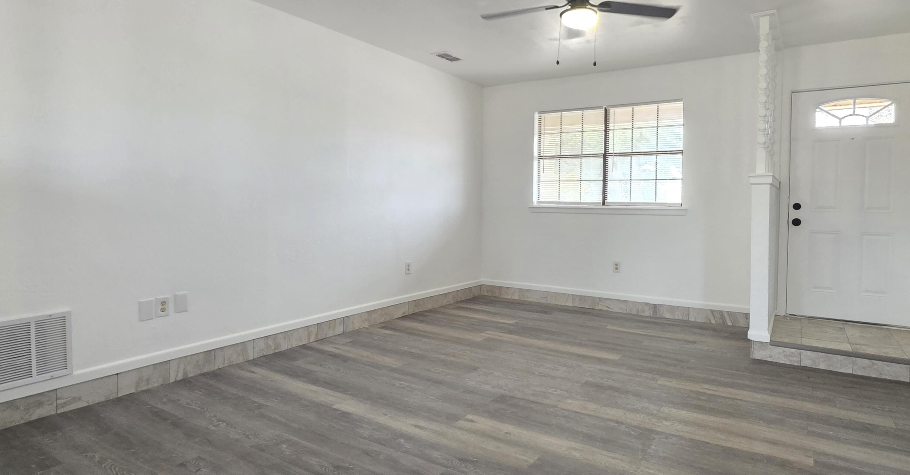 2307 78th Street Lubbock, TX 79423 - Photo 4 of 21 wooden floor in an empty room with a window