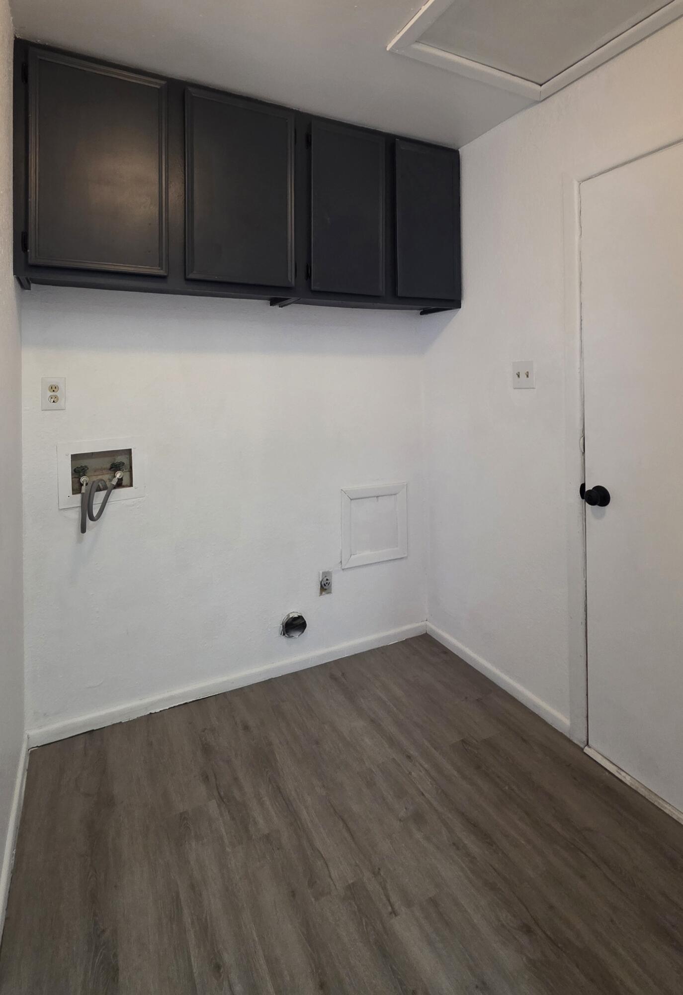 2307 78th Street Lubbock, TX 79423 - Photo 10 of 21 an empty room with wooden floor and cabinet