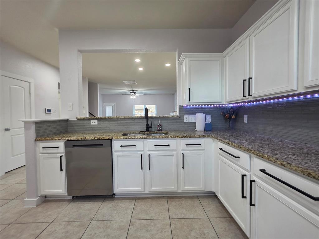 149 Ryan Street Anna, TX 75409 - Photo 13 of 38 a kitchen with a sink and cabinets