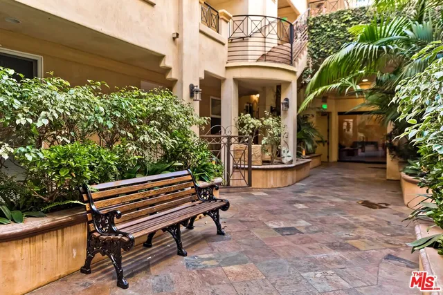 a backyard of a house with barbeque oven table and chairs