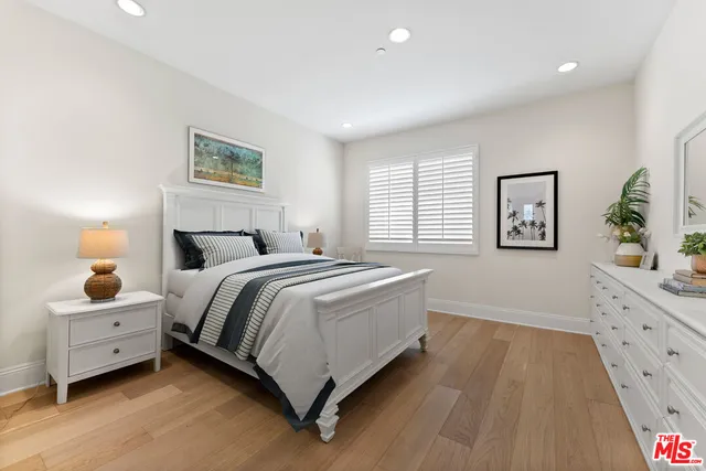 a bedroom with a bed and a night stand