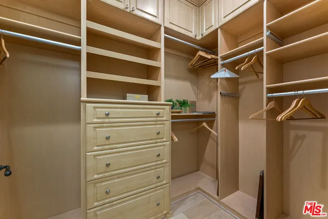a view of walk in closet with empty racks