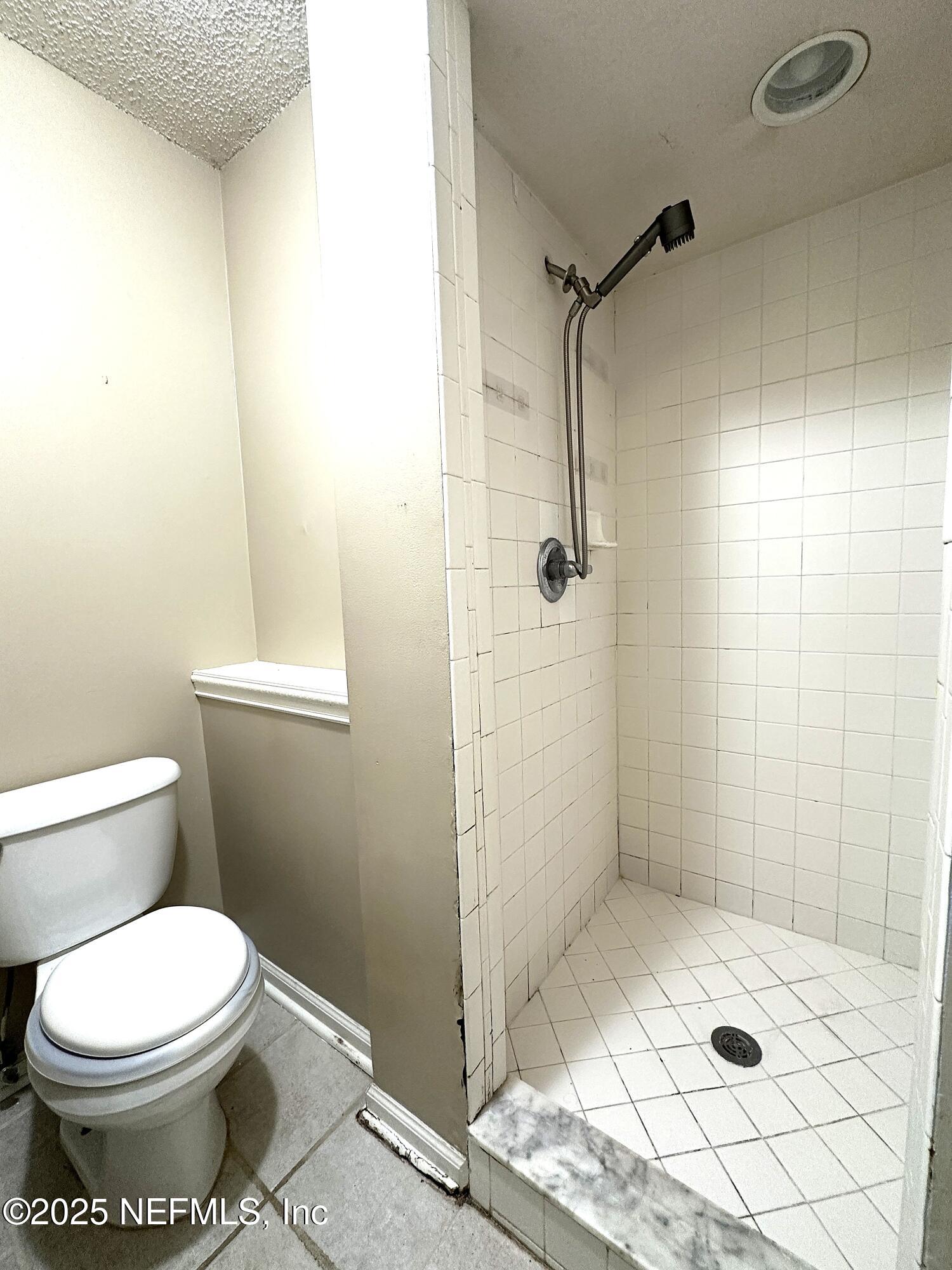 83041 St Mark Drive Yulee, FL 32097 - Photo 13 of 28 a bathroom with a toilet and shower