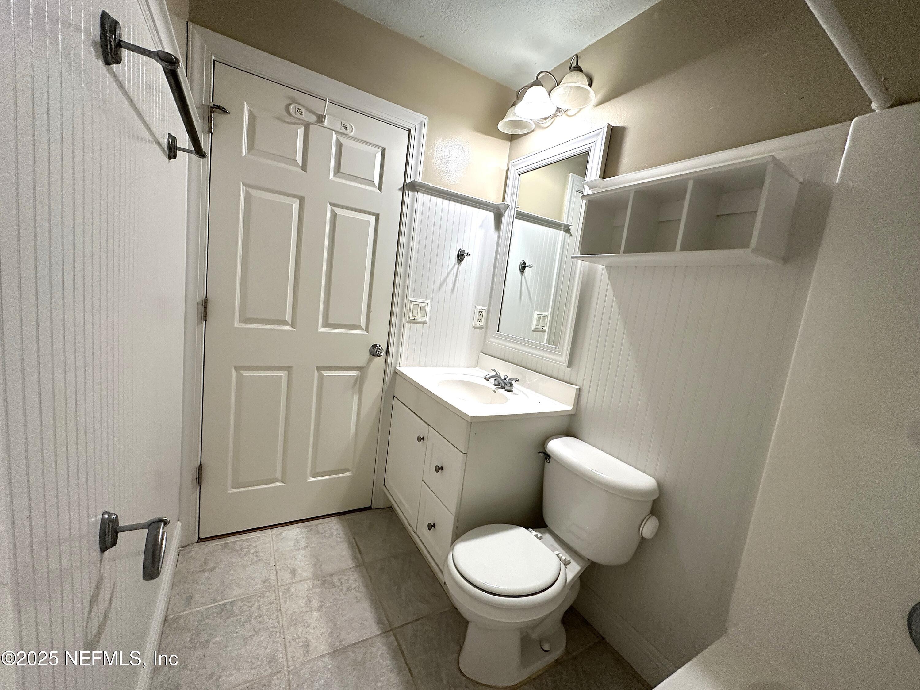 83041 St Mark Drive Yulee, FL 32097 - Photo 18 of 28 a bathroom with a toilet sink and mirror