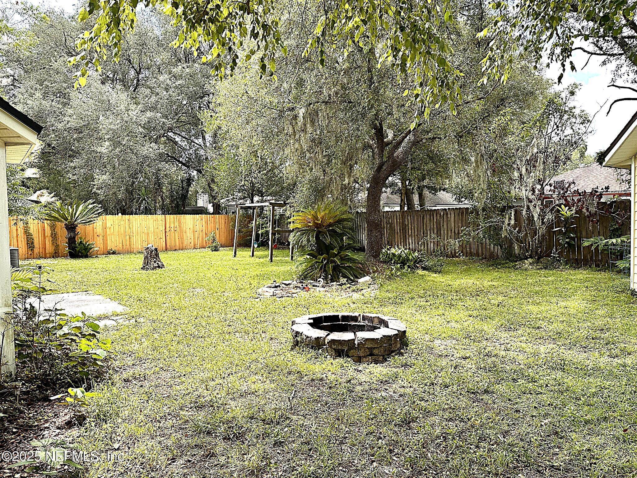 83041 St Mark Drive Yulee, FL 32097 - Photo 25 of 28 a view of a backyard with a garden