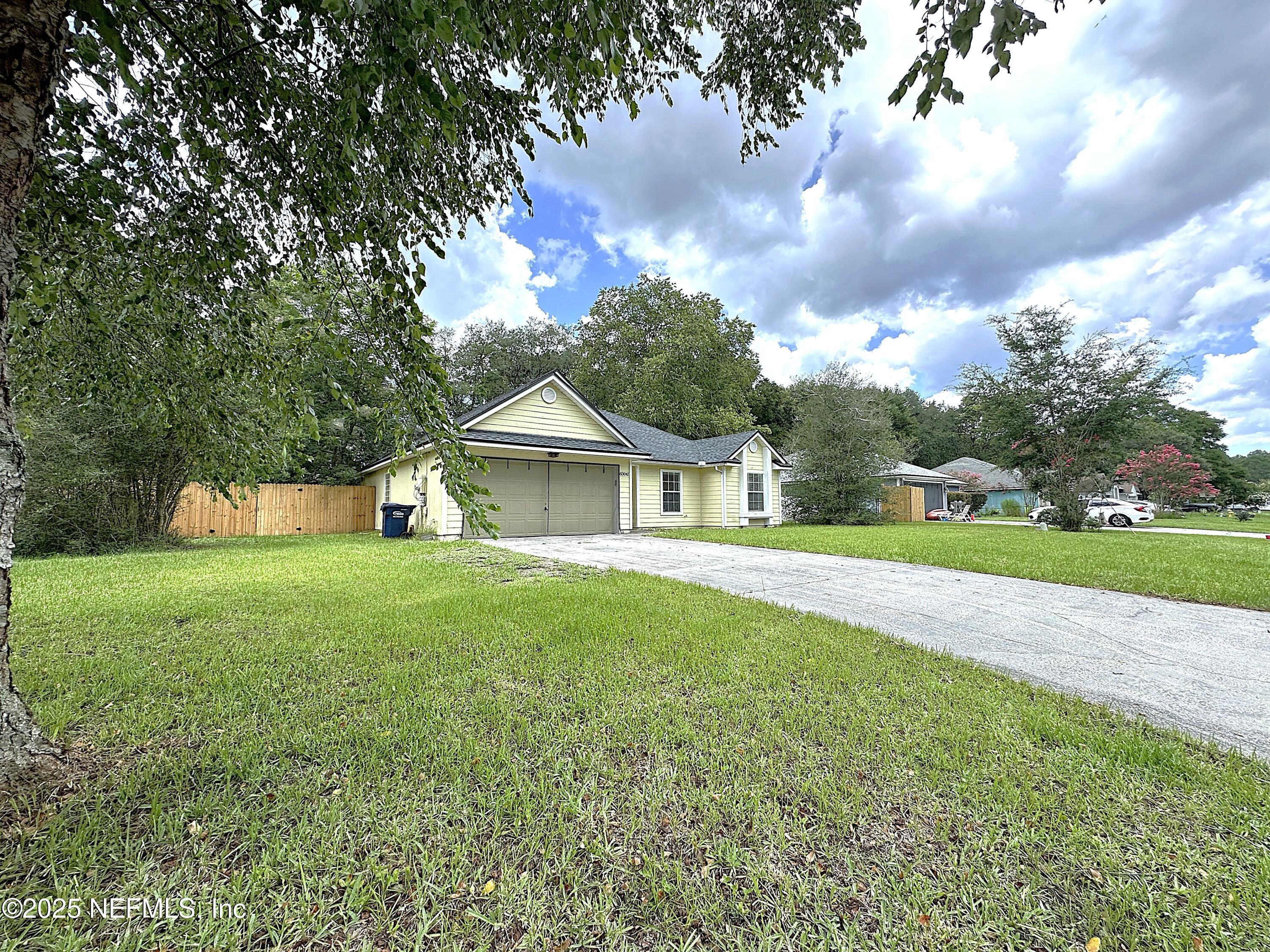 83041 St Mark Drive Yulee, FL 32097 - Photo 28 of 28 a front view of house with yard and green space