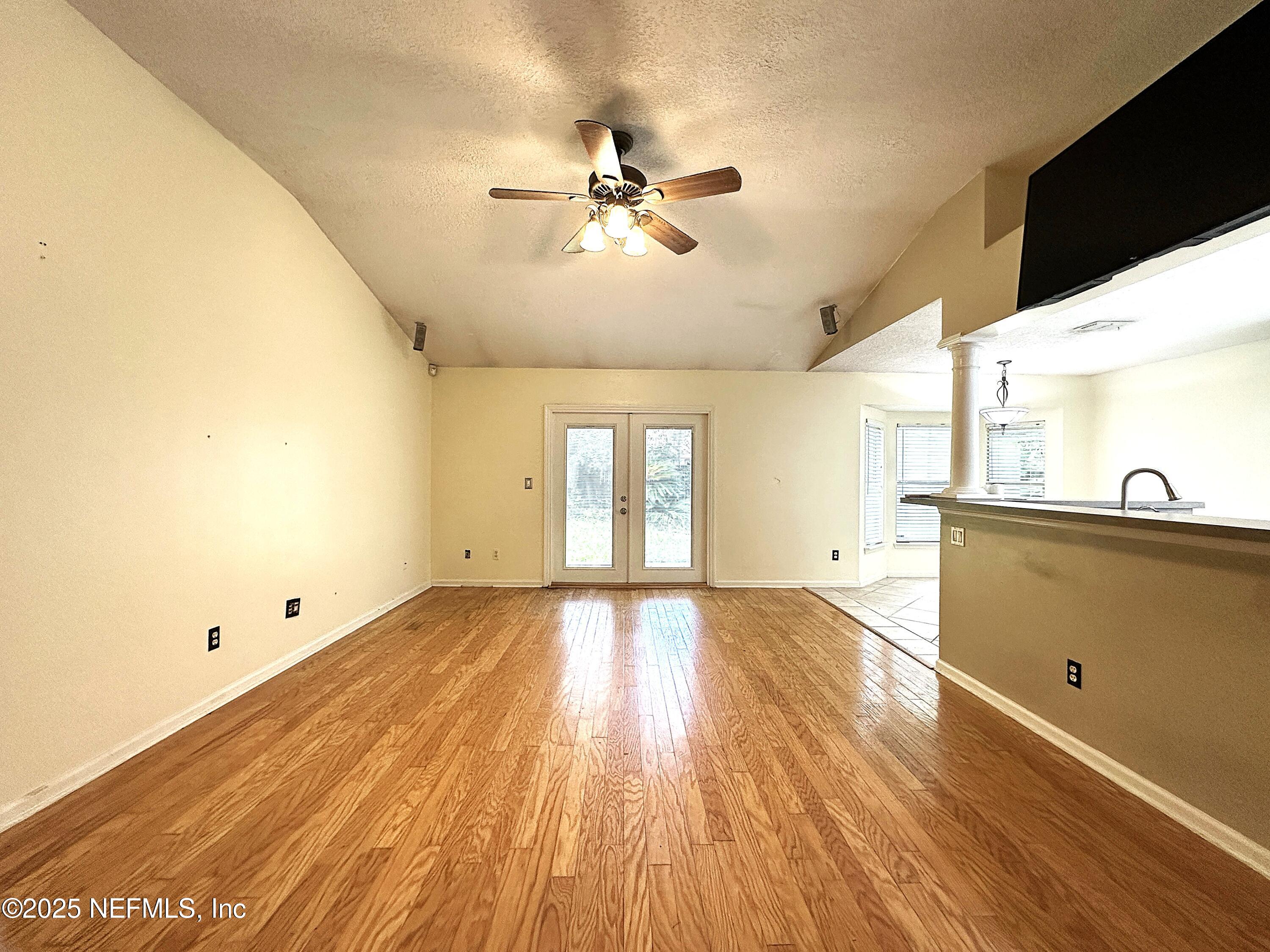 83041 St Mark Drive Yulee, FL 32097 - Photo 4 of 28 a view of empty room with wooden floor and fan